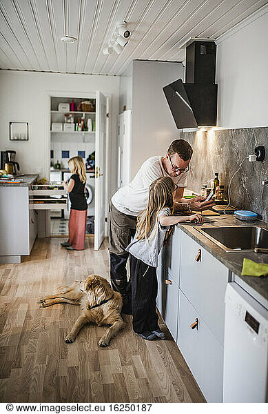 Father with daughter in kitchen