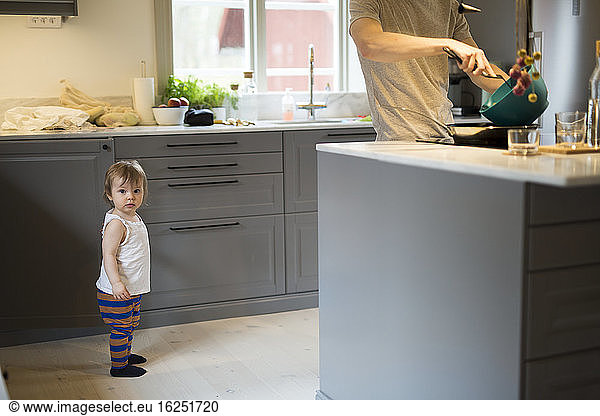 Father with daughter in kitchen