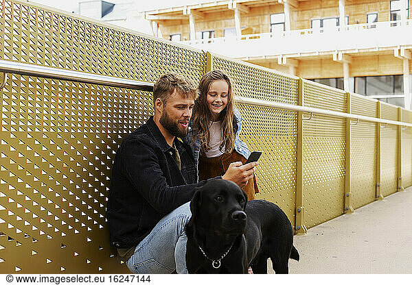 Father with daughter looking at cell phone