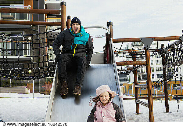 Father with daughter on slide