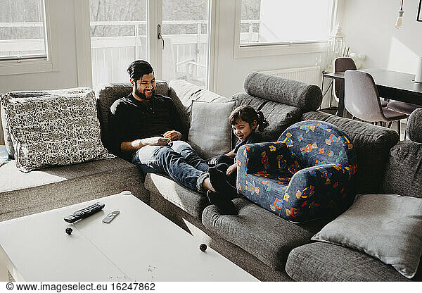 Father with daughter on sofa