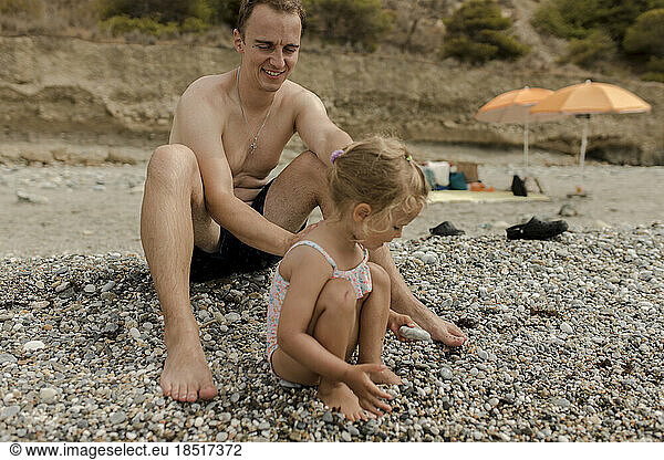 Father with daughter playing at beach