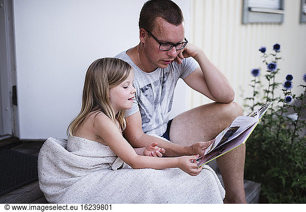 Father with daughter reading