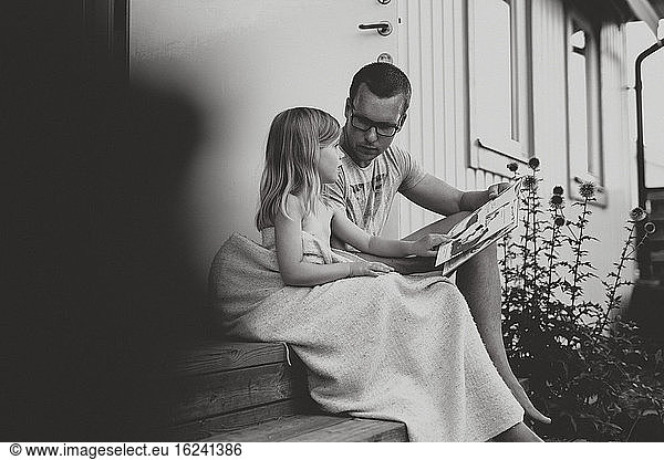 Father with daughter reading
