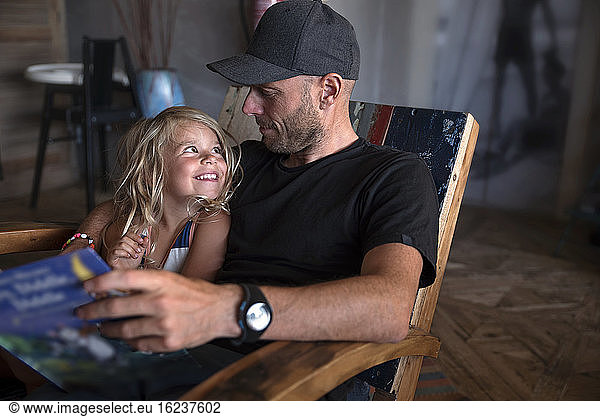 Father with daughter sitting together