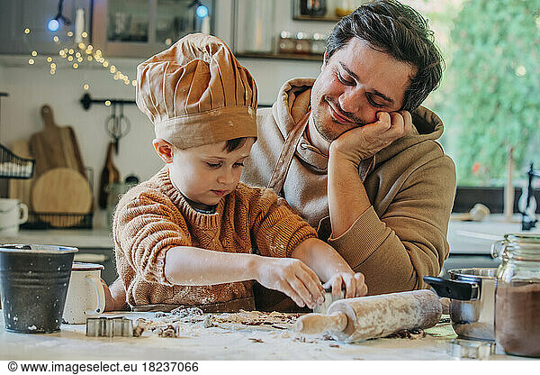 Father with son preparing cookies at home