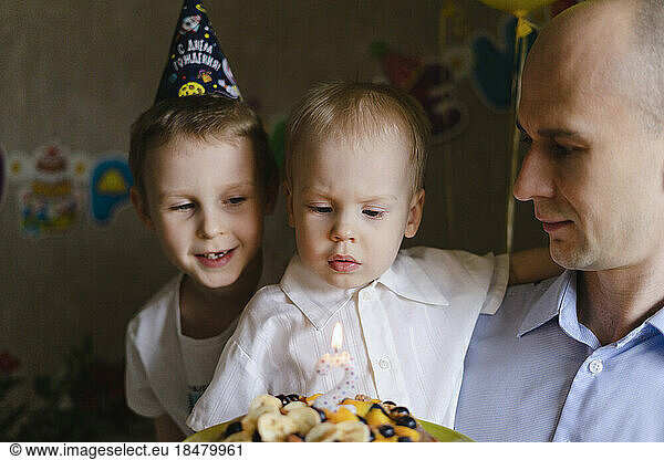 Father with son's celebrating birthday at home