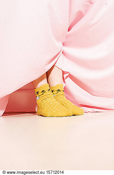 Feet of a little girl wearing dotted socks