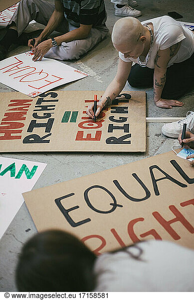 Female activist preparing human rights signboard
