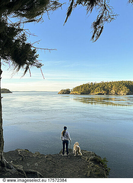 Female and dog hiking at Deception Pass State Park