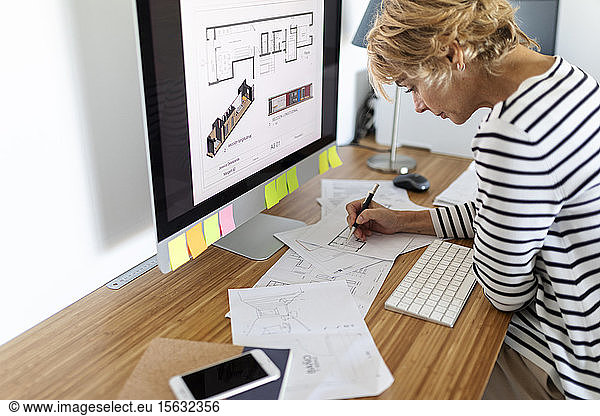 Female architect working on project in home office