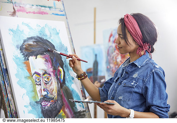Female artist painting in art studio
