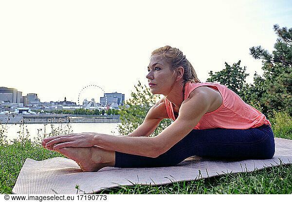 Female athlete doing yoga move in park