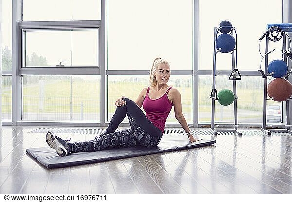 Female athlete exercising on mat