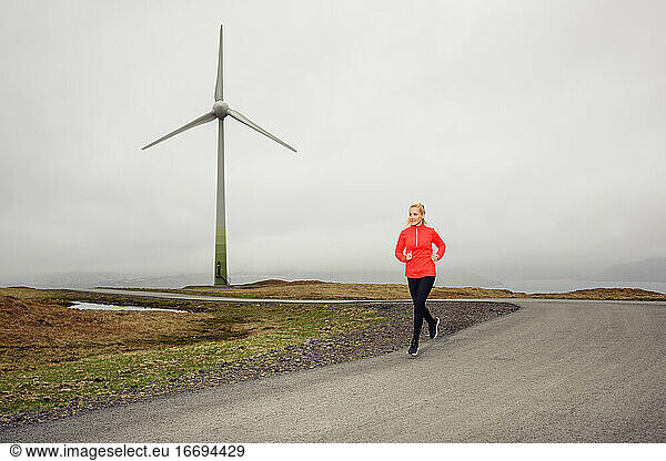Female athlete running on countryside road