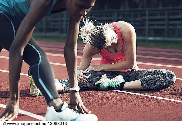 Female athletes exercising on track