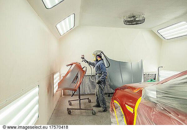 Female Auto worker prepping paint