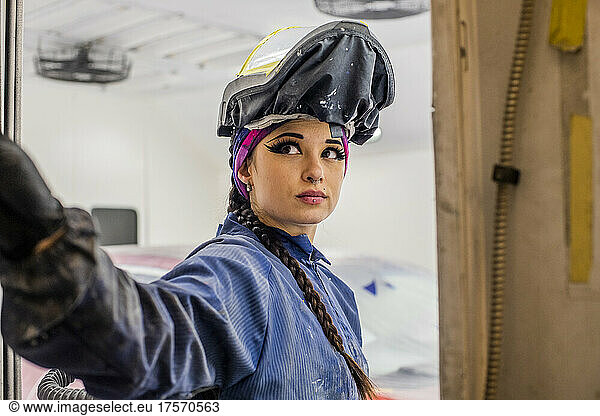 Female Auto worker prepping paint