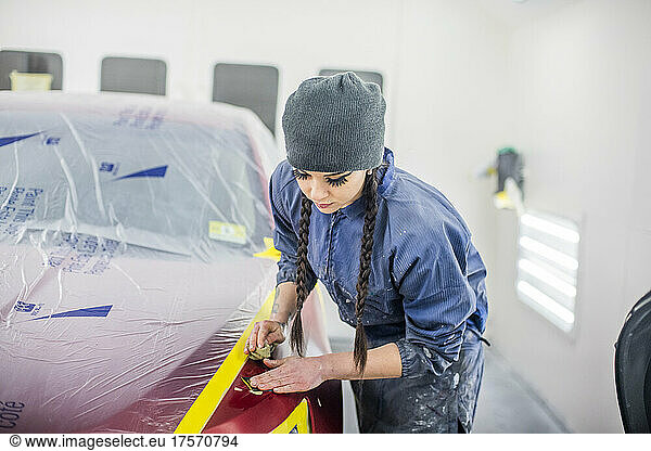 Female Auto worker prepping paint