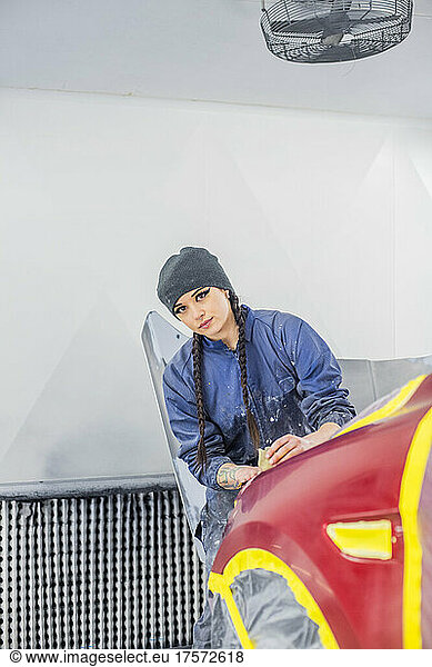 Female Auto worker prepping paint