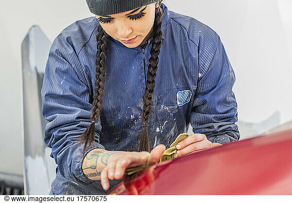 Female Auto worker sanding paint