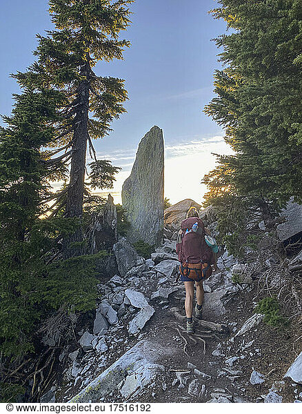 Female backpacking on a trail in the north cascade mountains