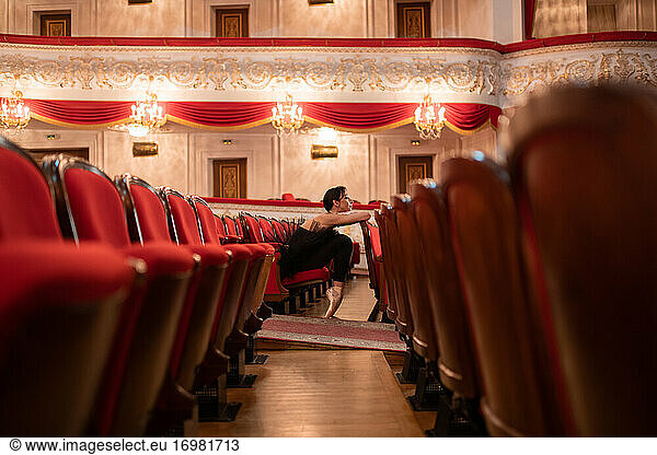 Female ballet dancer waiting for performance in auditorium