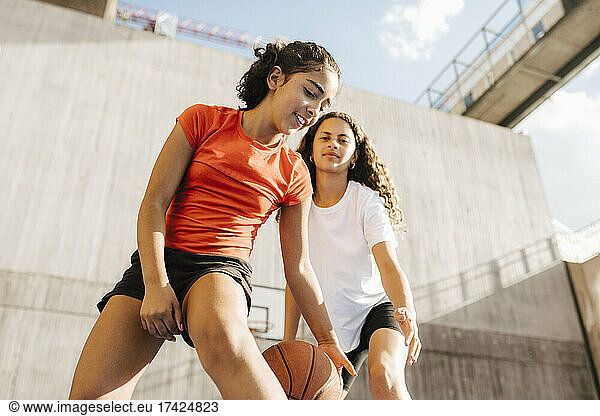 Female basketball players playing at sports court