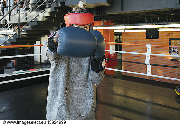 Female boxer punching in ring