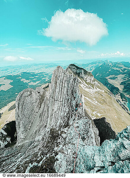 Female Climbers climbing on narrow ridge in Switzerland