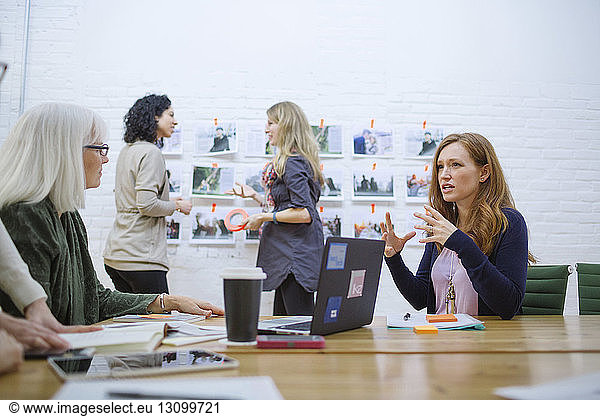 Female coworkers discussing in meeting at board room