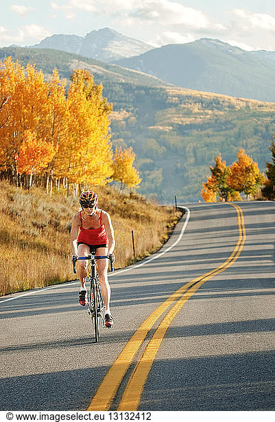 Female cyclist on mountain road