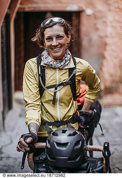 female cyclist stands for a portrait in a street in Marrakesh  Morocco