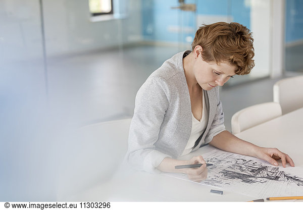 Female designer drawing sketch in office