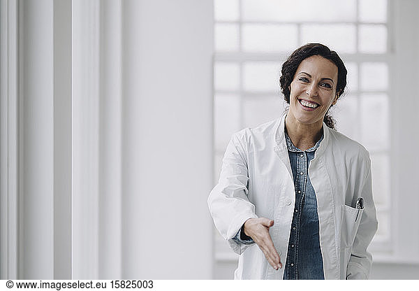 Female doctor reaching out hand for greeting