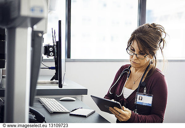 Female doctor using tablet computer in clinic