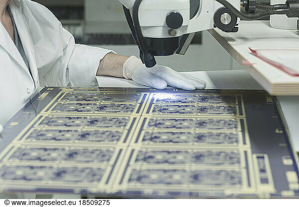 Female engineer examining circuit board in industry  Hanover  Lower Saxony  Germany