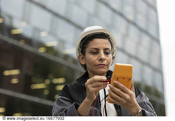 female engineer with helmet working outside
