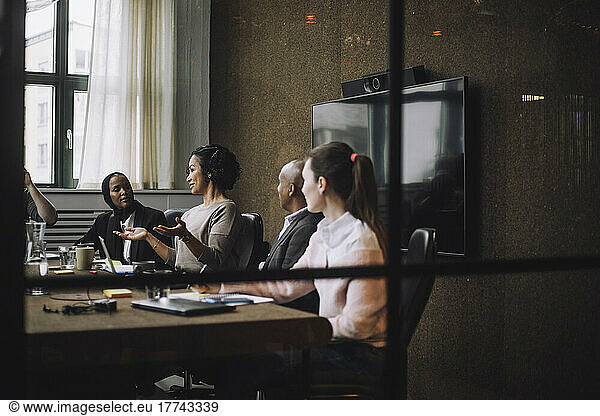Female entrepreneur discussing strategy with colleagues in meeting room