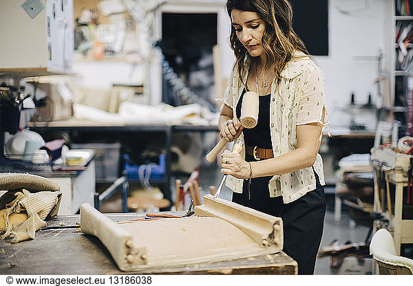 Female entrepreneur making furniture at workshop