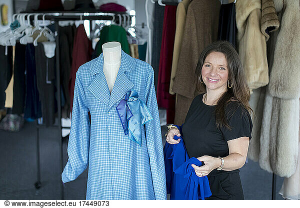 Female fashion entrepreneur with blue shirt smiling at camera