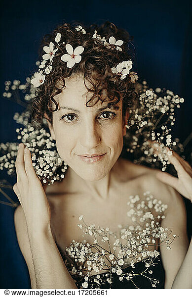 Female fashion model with white flowers in hair