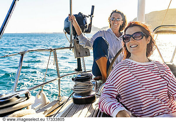 Female friends enjoying sunny day on sailing ship
