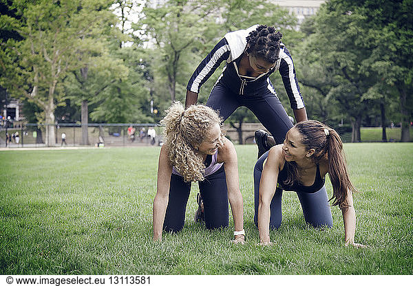 Female friends exercising at park