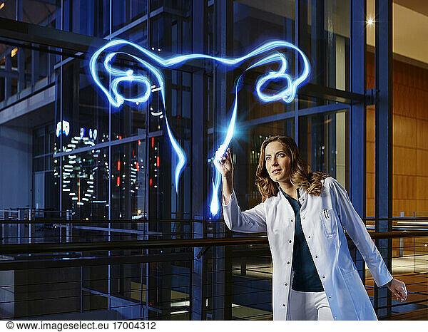 Female gynecologist light painting ovary in laboratory at hospital