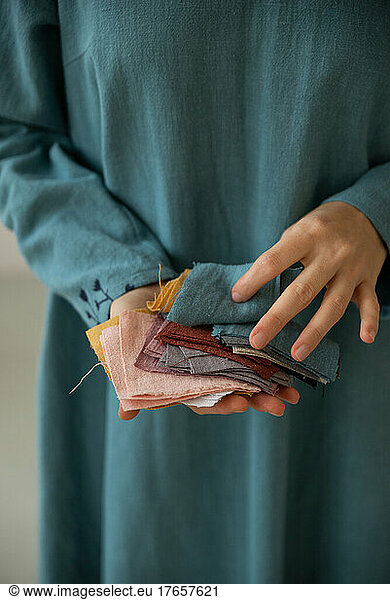 Female hands holding colourful pieces of linen tissue