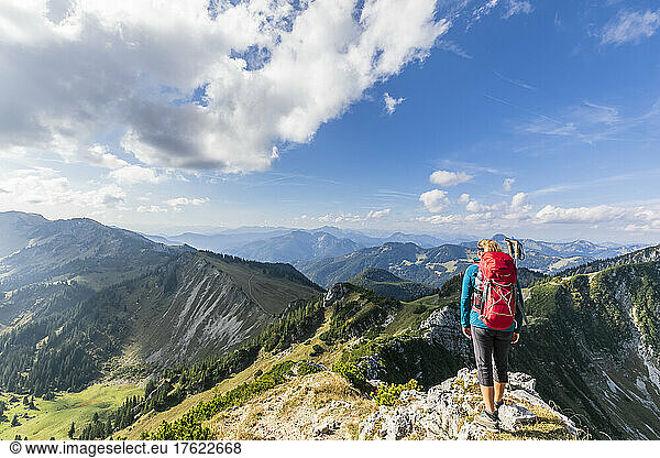 Female hiker admiring view from mountaintop
