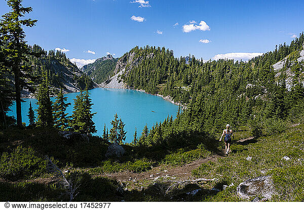 Female Hiking Past Beautiful Turquoise Alpine Lake