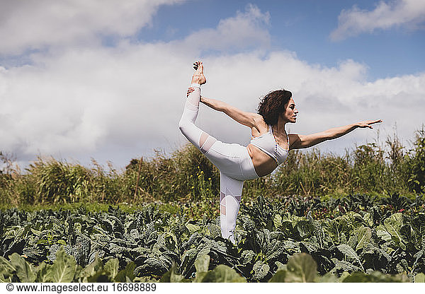 Female in dancer's pose in a vegetable field