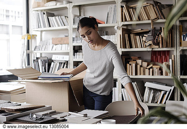 Female interior designer examining files in office
